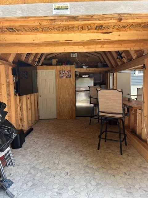 basement featuring wooden walls