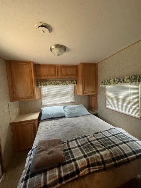 unfurnished bedroom featuring multiple windows