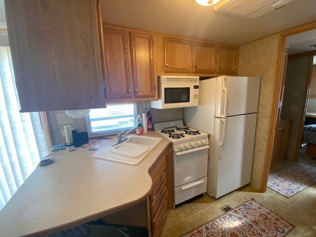 kitchen with sink and white appliances