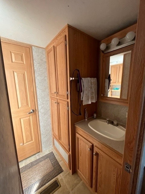 bathroom with tile patterned flooring and vanity