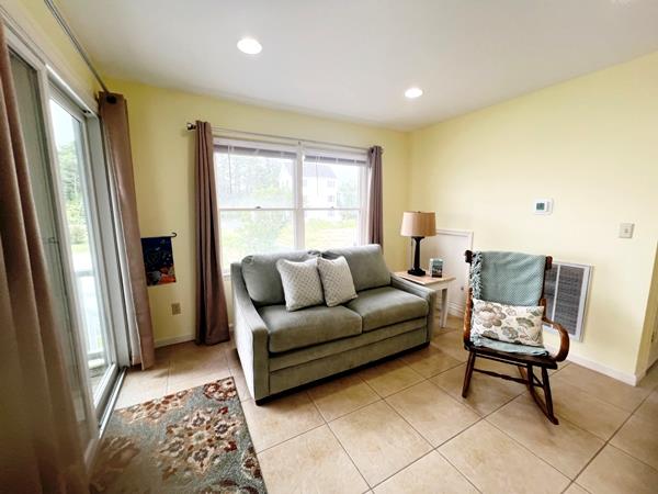 5061 Bay Colony Ln, Chincoteague, VA 23336 - living room featuring healthy amount of natural light, light tile patterned floors, baseboards, and recessed lighting