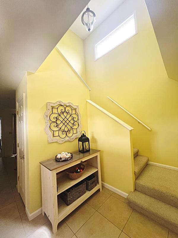 5061 Bay Colony Ln, Chincoteague, VA 23336 - stairway featuring tile patterned floors and baseboards