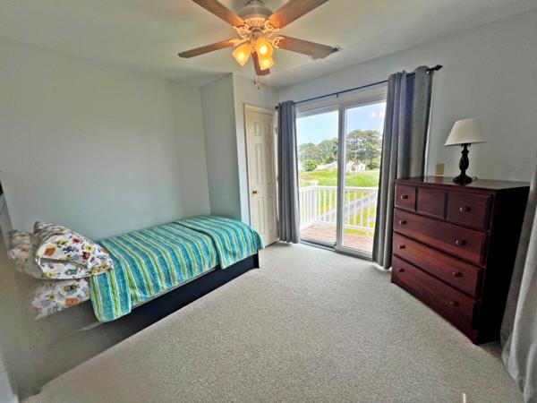 5061 Bay Colony Ln, Chincoteague, VA 23336 - bedroom featuring access to exterior, carpet, and a ceiling fan