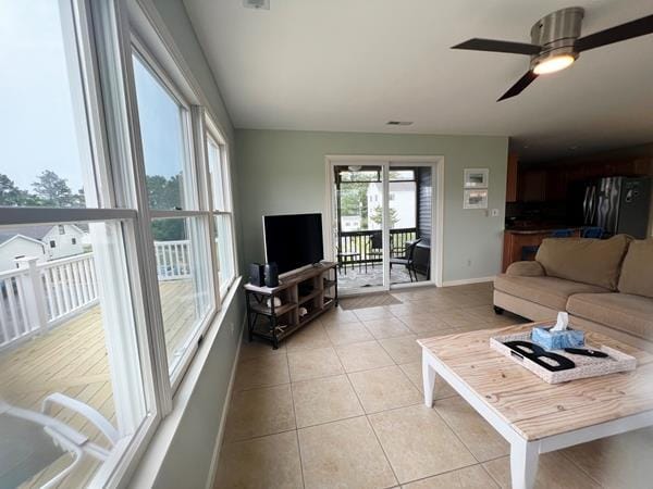 5061 Bay Colony Ln, Chincoteague, VA 23336 - living area featuring light tile patterned floors, baseboards, and a ceiling fan