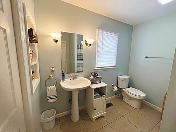 5061 Bay Colony Ln, Chincoteague, VA 23336 - bathroom with toilet, tile patterned flooring, and baseboards