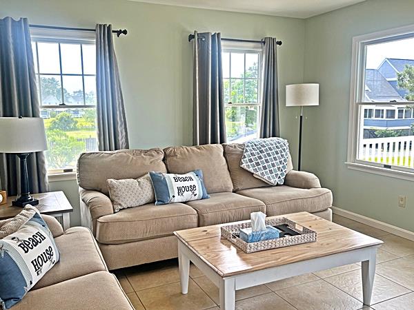 5061 Bay Colony Ln, Chincoteague, VA 23336 - living room with light tile patterned floors and baseboards