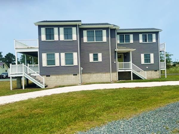 5061 Bay Colony Ln, Chincoteague, VA 23336 - view of front of house with a front lawn, crawl space, and a balcony