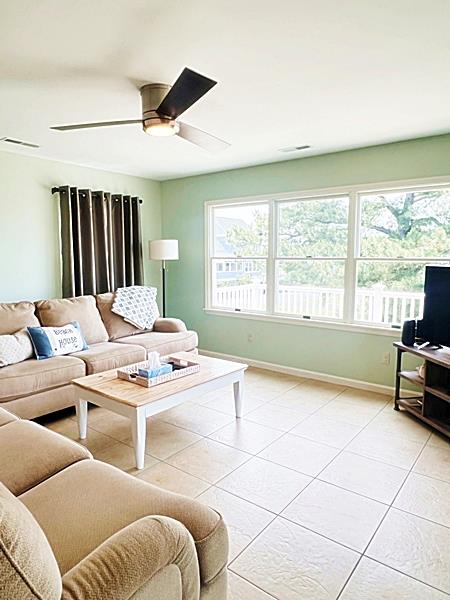 5061 Bay Colony Ln, Chincoteague, VA 23336 - living room featuring baseboards, a ceiling fan, and light tile patterned flooring