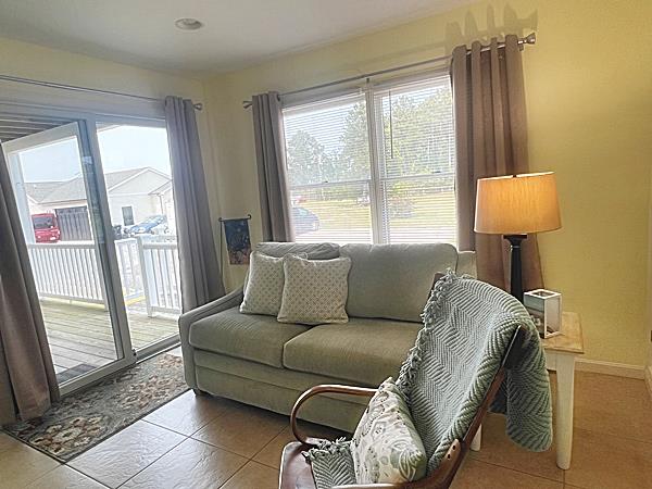 5061 Bay Colony Ln, Chincoteague, VA 23336 - living room with tile patterned floors and baseboards