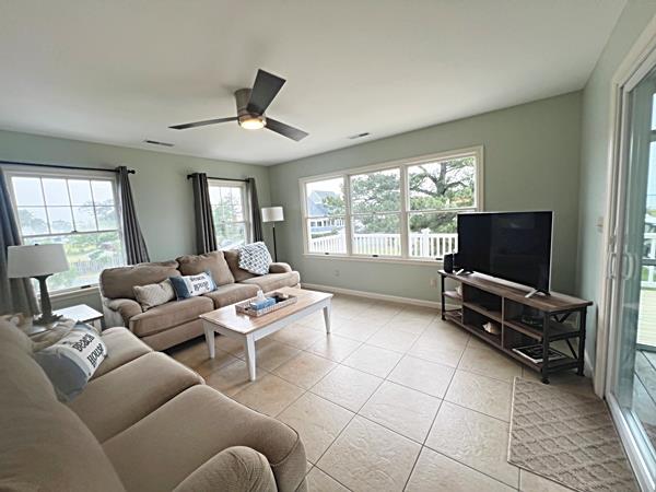5061 Bay Colony Ln, Chincoteague, VA 23336 - living area featuring ceiling fan, light tile patterned flooring, and baseboards