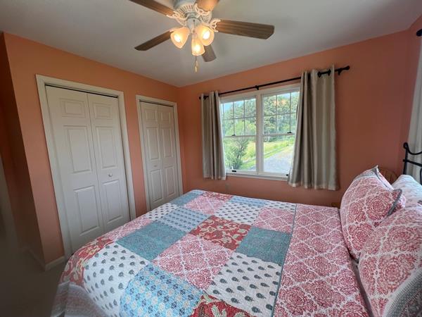 5061 Bay Colony Ln, Chincoteague, VA 23336 - bedroom featuring two closets and a ceiling fan