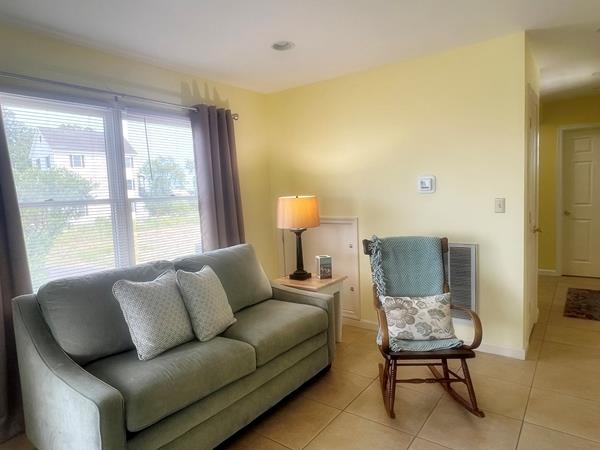 5061 Bay Colony Ln, Chincoteague, VA 23336 - living area featuring light tile patterned floors and baseboards