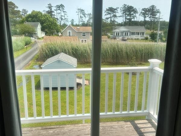 5061 Bay Colony Ln, Chincoteague, VA 23336 - entryway with healthy amount of natural light and wood finished floors