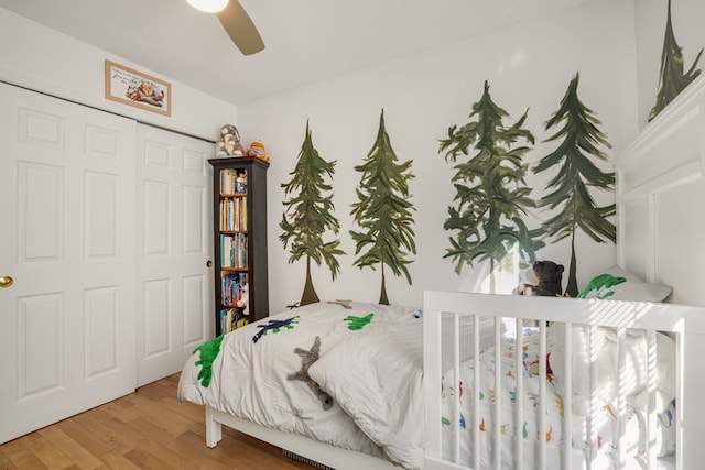 bedroom featuring hardwood / wood-style flooring, a closet, and ceiling fan