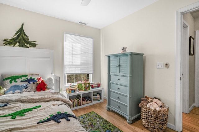 bedroom with light wood-type flooring and ceiling fan