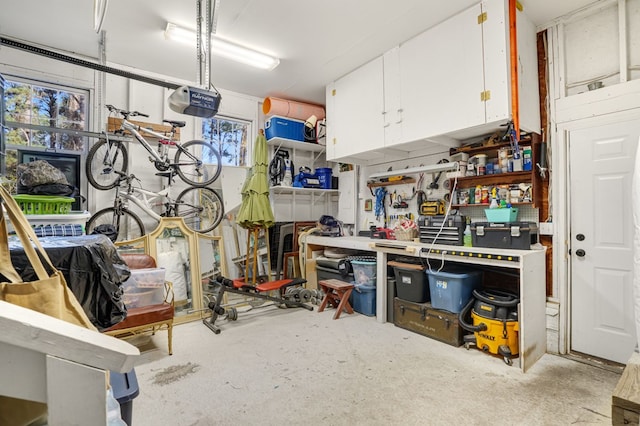 garage with a workshop area and a garage door opener