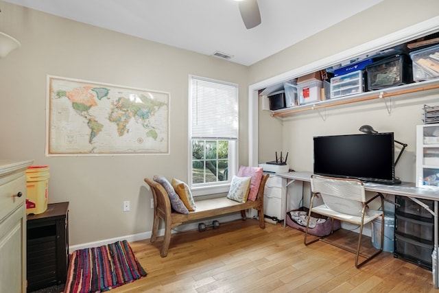 home office with light hardwood / wood-style flooring and ceiling fan