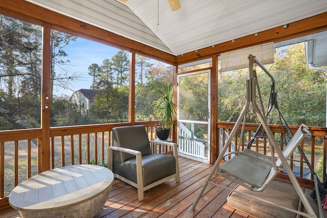 sunroom with ceiling fan, a healthy amount of sunlight, and lofted ceiling