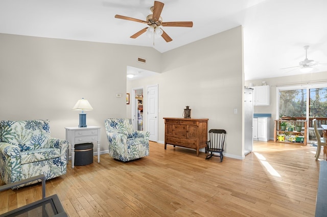 sitting room with light hardwood / wood-style flooring, ceiling fan, and lofted ceiling