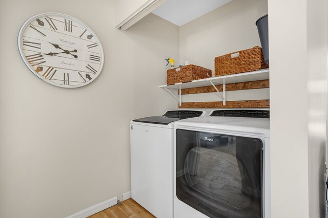 washroom featuring washer and dryer and light wood-type flooring