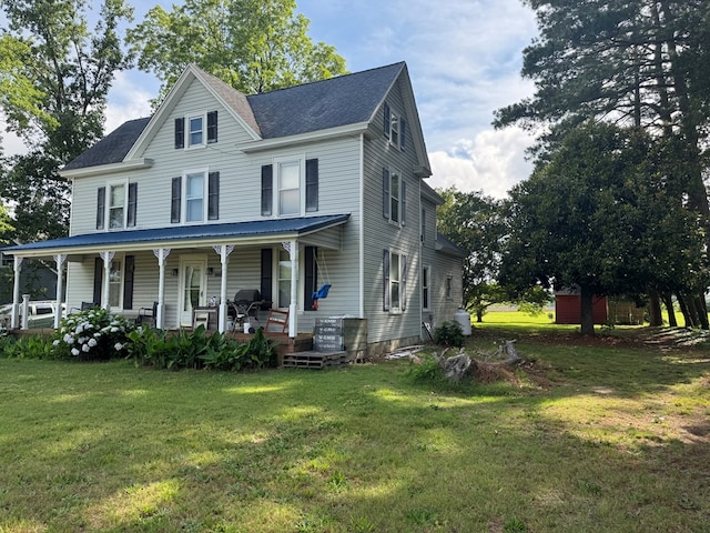 22338 Accomac Rd, Accomac, VA 23301 - view of front of house featuring a porch, a front yard, and a shingled roof