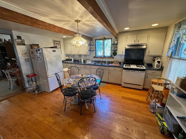 kitchen with white appliances, sink, beam ceiling, decorative light fixtures, and light hardwood / wood-style flooring