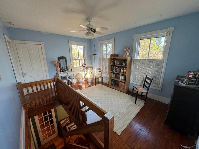 interior space with ceiling fan, dark wood-type flooring, and a wealth of natural light