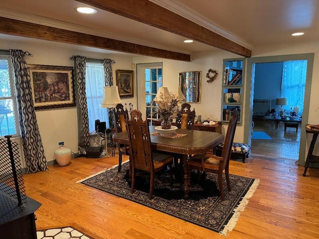 dining area with beamed ceiling, wood-type flooring, and plenty of natural light