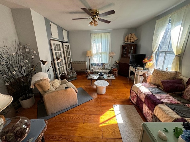 living room featuring ceiling fan and hardwood / wood-style flooring