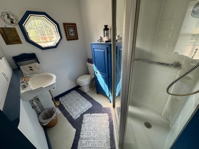 bathroom featuring a shower and toilet