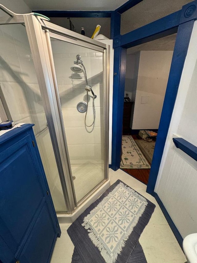 bathroom with a shower with shower door