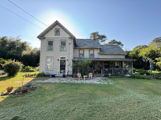 rear view of property with a lawn