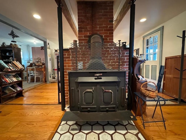 room details with hardwood / wood-style floors and a wood stove