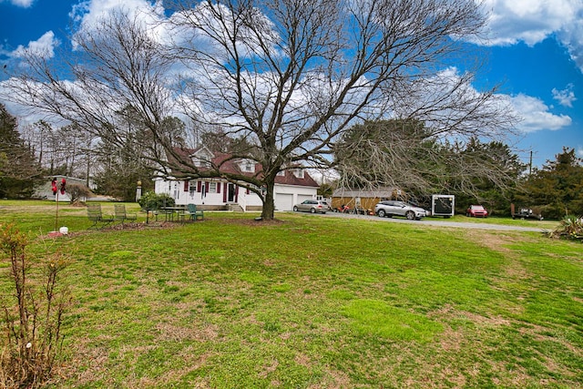 13091 Bethel Church Rd, Hallwood, VA 23359 - view of grassy yard with driveway and an attached garage