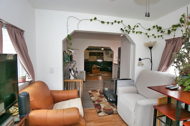 13091 Bethel Church Rd, Hallwood, VA 23359 - living room featuring light wood-style floors, arched walkways, and healthy amount of natural light