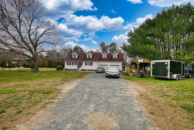 13091 Bethel Church Rd, Hallwood, VA 23359 - cape cod-style house with gravel driveway, a garage, and a front lawn