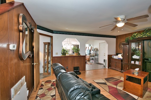 13091 Bethel Church Rd, Hallwood, VA 23359 - living area featuring light wood-type flooring, ceiling fan, and arched walkways
