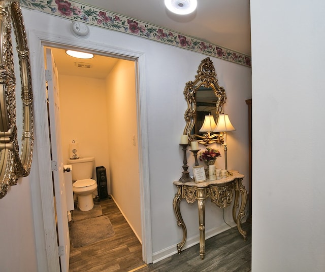 13091 Bethel Church Rd, Hallwood, VA 23359 - bathroom with toilet, wood finished floors, and baseboards