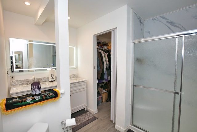 13091 Bethel Church Rd, Hallwood, VA 23359 - full bath featuring wood finished floors, vanity, a shower stall, a walk in closet, and recessed lighting