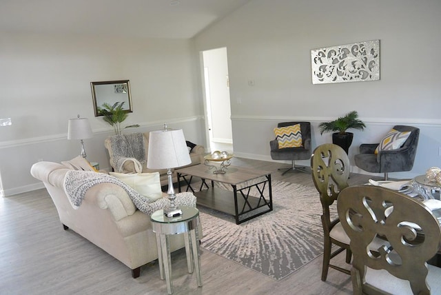 living room with light hardwood / wood-style flooring and lofted ceiling