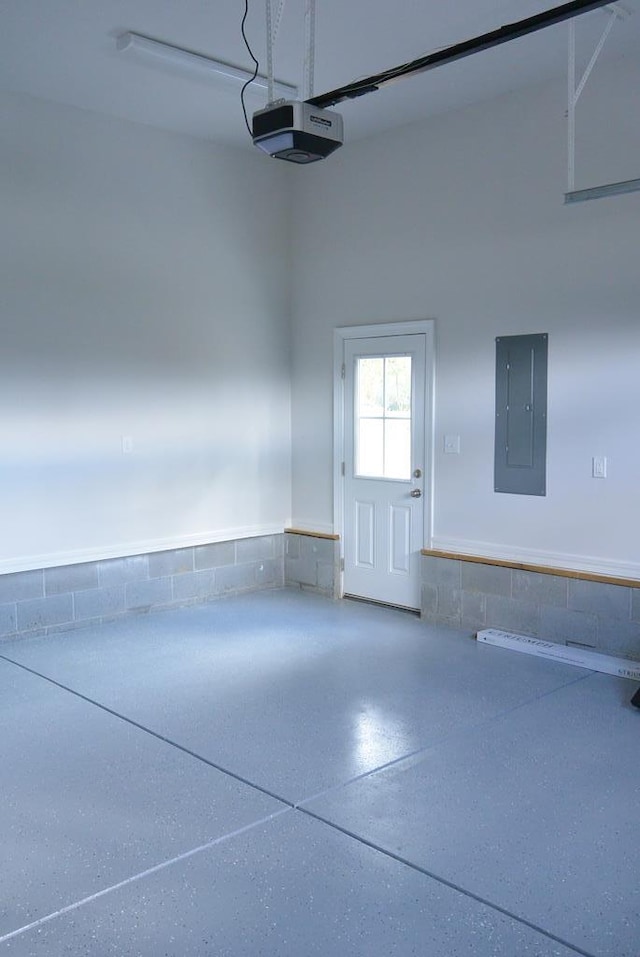 garage with electric panel and a garage door opener