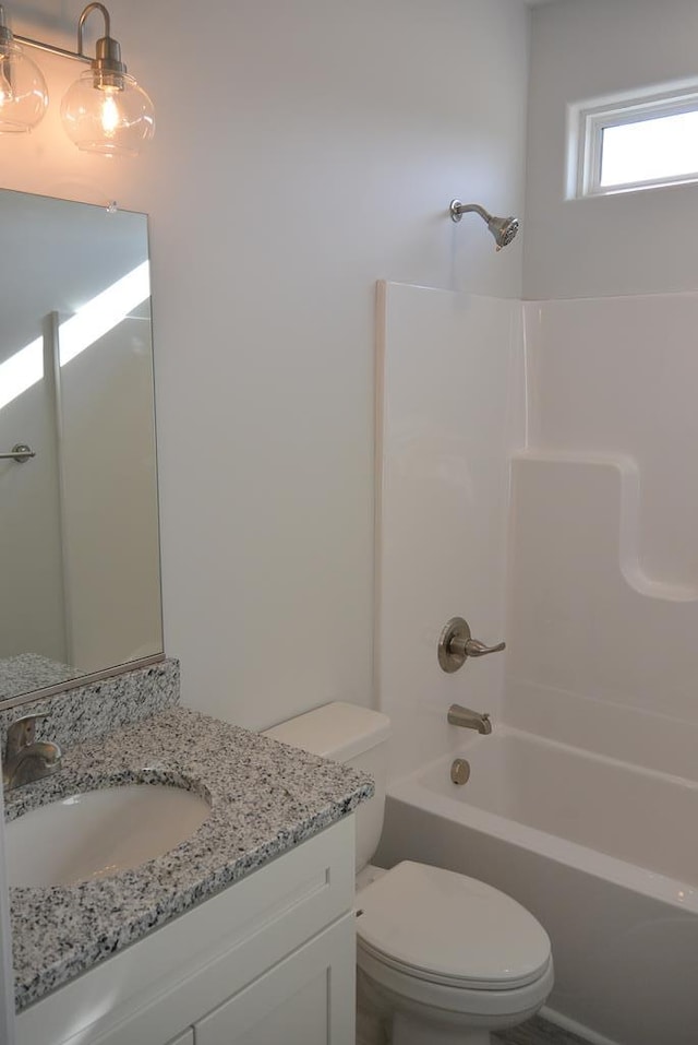 full bathroom featuring bathing tub / shower combination, vanity, and toilet