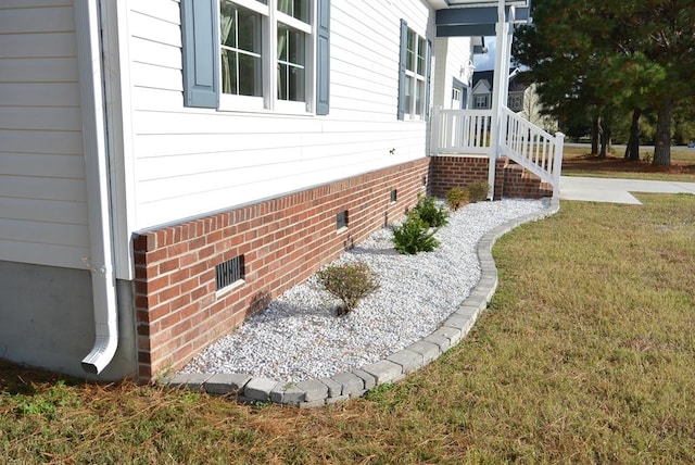 view of side of home featuring a yard