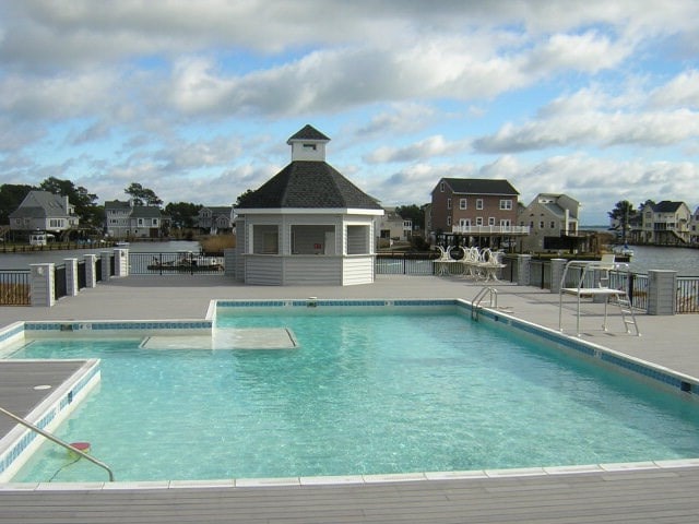 view of swimming pool with a patio area and an outbuilding