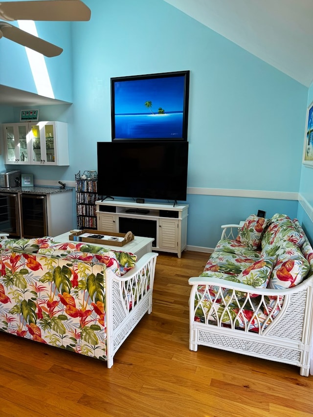 bedroom featuring vaulted ceiling, beverage cooler, and wood-type flooring