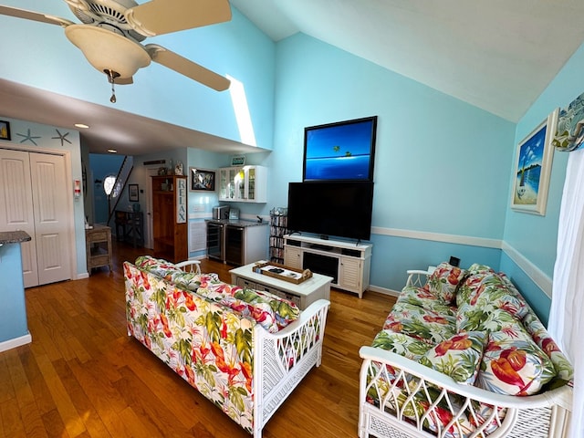 living room featuring high vaulted ceiling, dark hardwood / wood-style floors, and ceiling fan