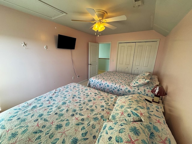 bedroom featuring lofted ceiling, ceiling fan, and a closet