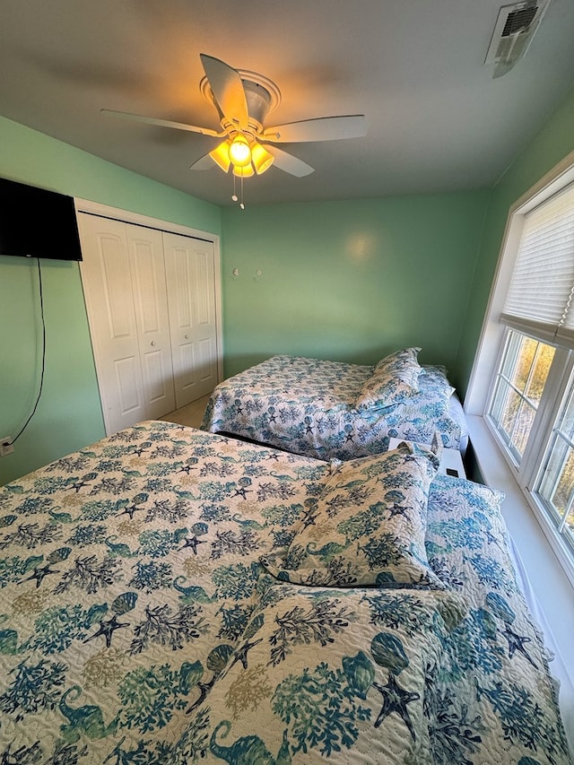 bedroom featuring multiple windows and ceiling fan