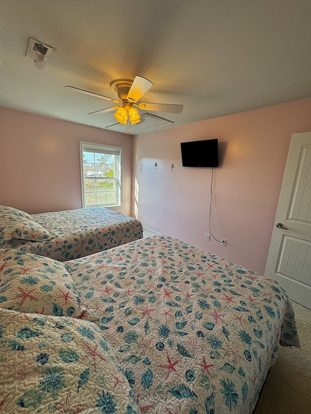 bedroom with ceiling fan and carpet floors