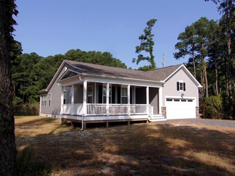 view of front facade featuring a porch and a garage